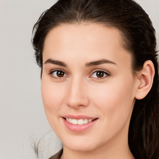 Joyful white young-adult female with long  brown hair and brown eyes