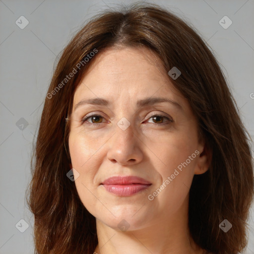 Joyful white adult female with long  brown hair and brown eyes