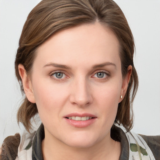 Joyful white young-adult female with medium  brown hair and blue eyes