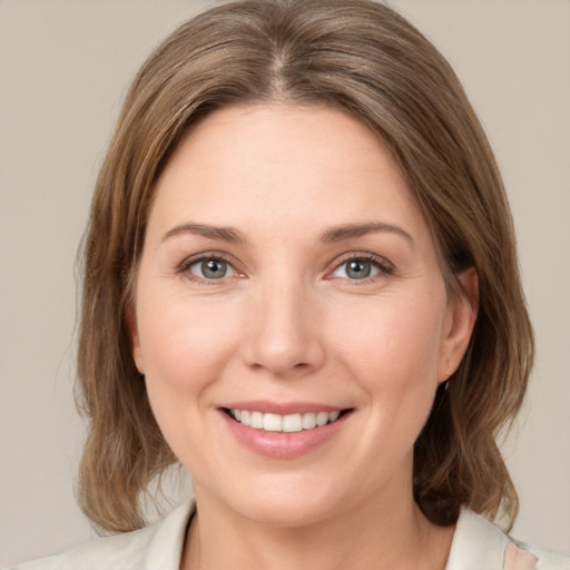 Joyful white young-adult female with medium  brown hair and green eyes