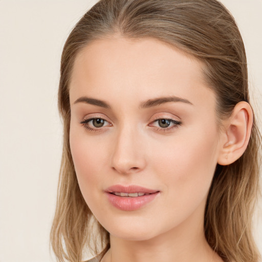 Joyful white young-adult female with long  brown hair and blue eyes