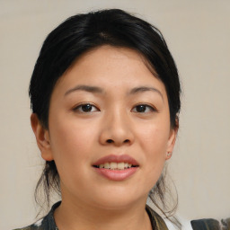 Joyful asian young-adult female with medium  brown hair and brown eyes