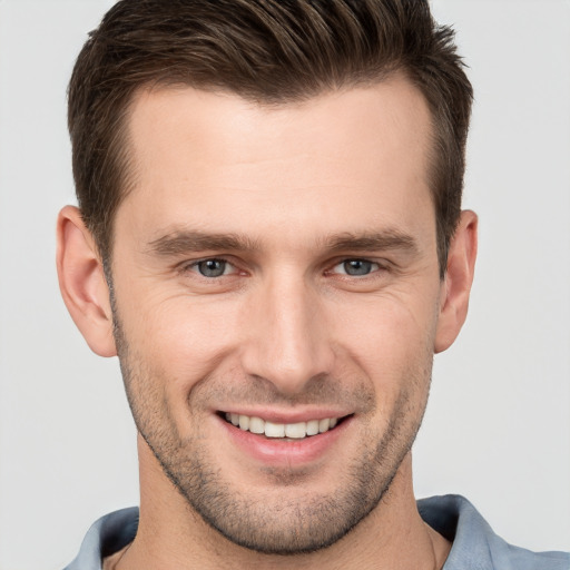 Joyful white young-adult male with short  brown hair and brown eyes