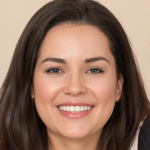 Joyful white young-adult female with long  brown hair and brown eyes