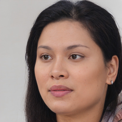 Joyful asian young-adult female with long  brown hair and brown eyes