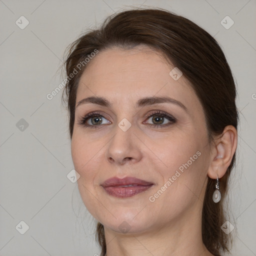 Joyful white adult female with medium  brown hair and brown eyes