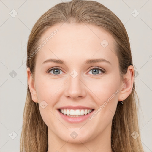 Joyful white young-adult female with long  brown hair and blue eyes