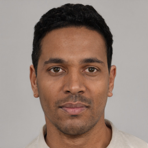 Neutral latino young-adult male with short  black hair and brown eyes