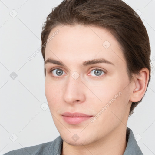 Joyful white young-adult female with short  brown hair and grey eyes