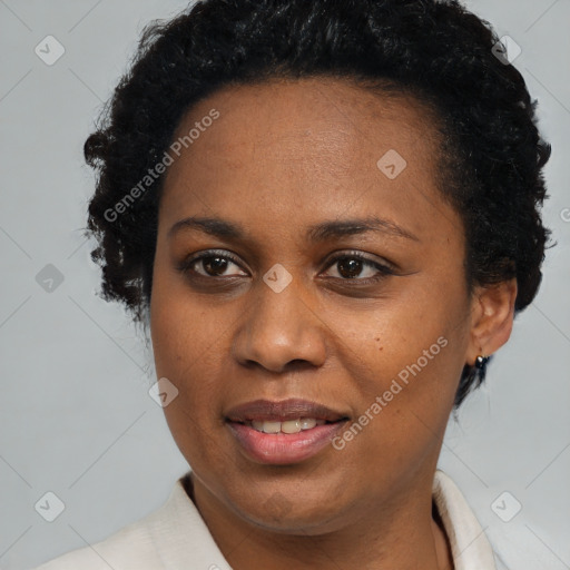 Joyful black adult female with short  black hair and brown eyes