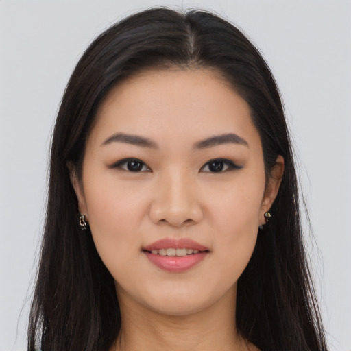 Joyful asian young-adult female with long  brown hair and brown eyes