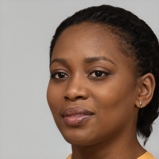 Joyful black young-adult female with medium  black hair and brown eyes