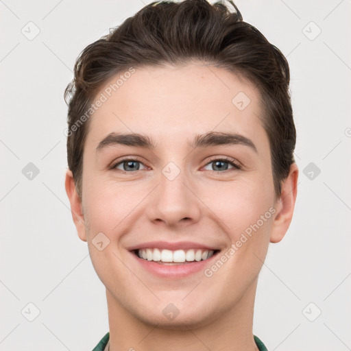 Joyful white young-adult male with short  brown hair and grey eyes