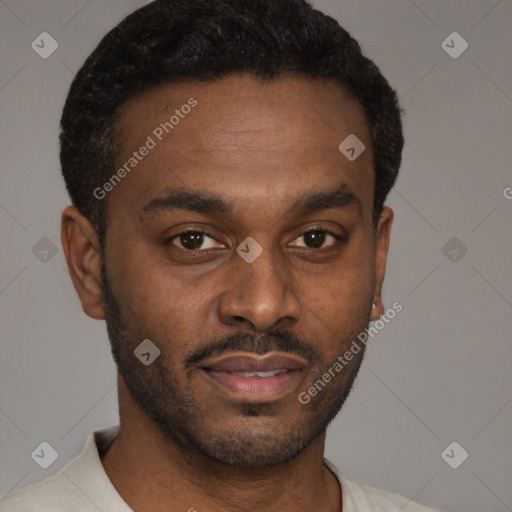 Joyful black young-adult male with short  brown hair and brown eyes