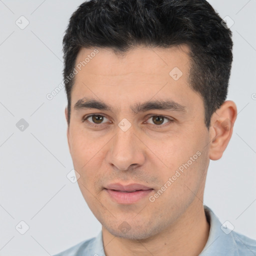 Joyful white young-adult male with short  black hair and brown eyes