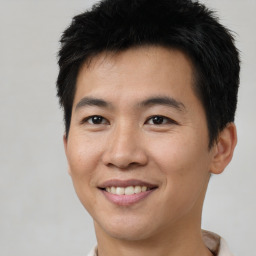 Joyful asian young-adult male with short  brown hair and brown eyes