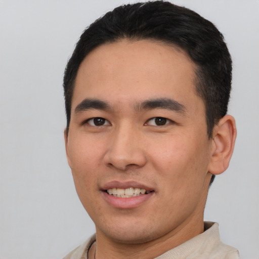 Joyful asian young-adult male with short  black hair and brown eyes