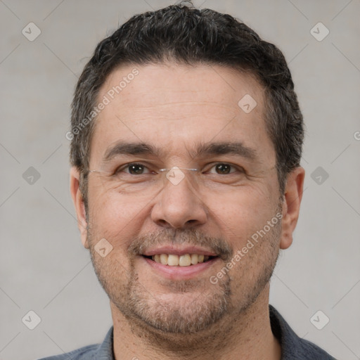 Joyful white adult male with short  black hair and brown eyes