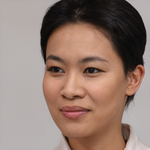 Joyful asian young-adult female with medium  black hair and brown eyes