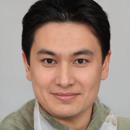 Joyful asian young-adult male with short  brown hair and brown eyes