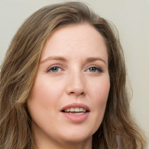 Joyful white young-adult female with long  brown hair and green eyes