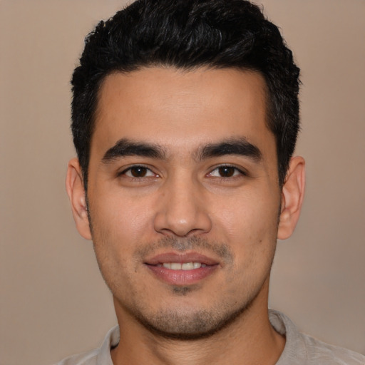 Joyful latino young-adult male with short  black hair and brown eyes