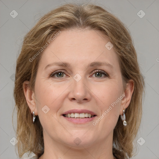 Joyful white adult female with medium  brown hair and grey eyes