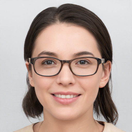 Joyful white young-adult female with medium  brown hair and brown eyes