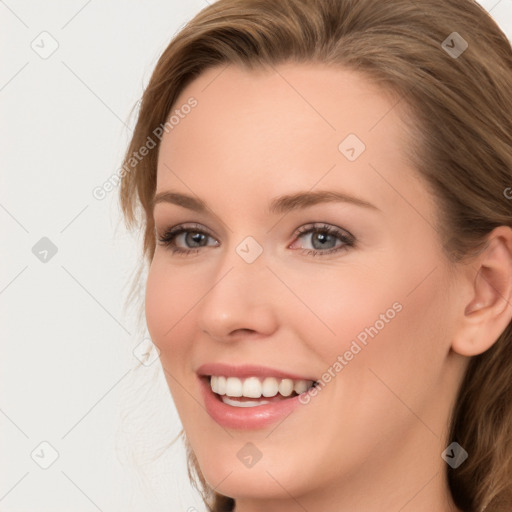 Joyful white young-adult female with long  brown hair and blue eyes