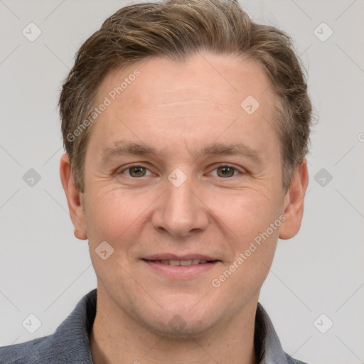 Joyful white adult male with short  brown hair and grey eyes