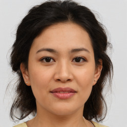 Joyful asian young-adult female with medium  brown hair and brown eyes