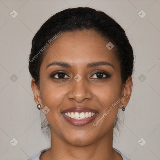 Joyful black young-adult female with short  brown hair and brown eyes