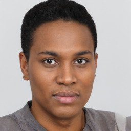 Joyful black young-adult male with short  black hair and brown eyes