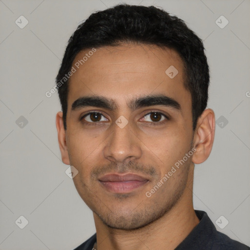 Joyful latino young-adult male with short  black hair and brown eyes