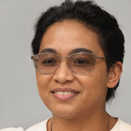 Joyful latino adult female with short  brown hair and brown eyes