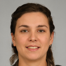 Joyful white young-adult female with medium  brown hair and grey eyes