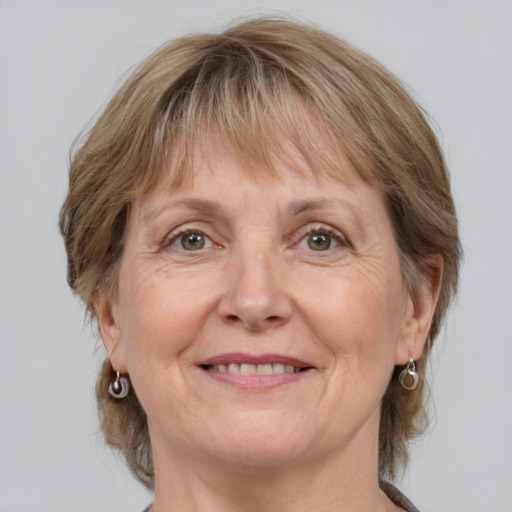 Joyful white adult female with medium  brown hair and grey eyes