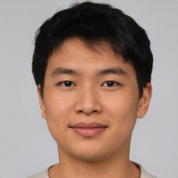 Joyful asian young-adult male with short  brown hair and brown eyes