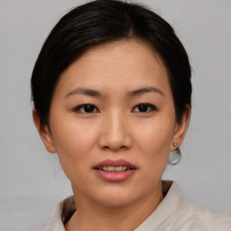 Joyful asian young-adult female with short  brown hair and brown eyes