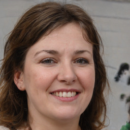 Joyful white adult female with medium  brown hair and brown eyes