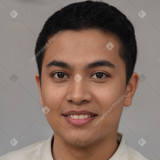 Joyful latino young-adult male with short  black hair and brown eyes