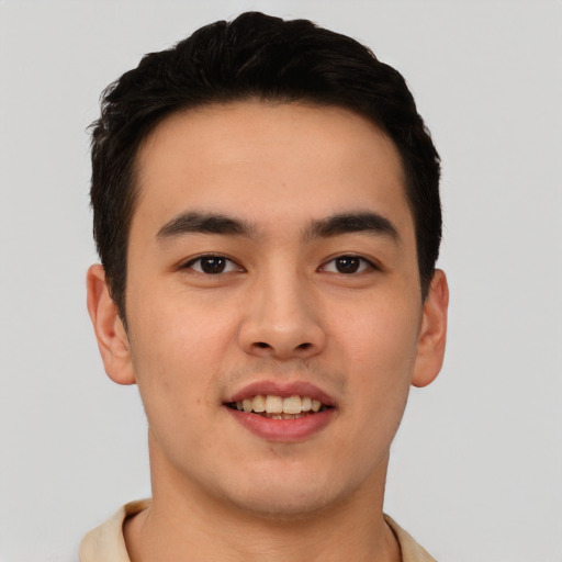 Joyful asian young-adult male with short  black hair and brown eyes