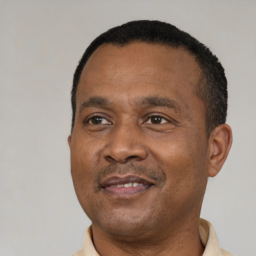 Joyful black adult male with short  black hair and brown eyes