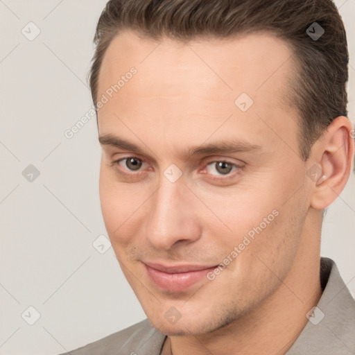 Joyful white young-adult male with short  brown hair and brown eyes