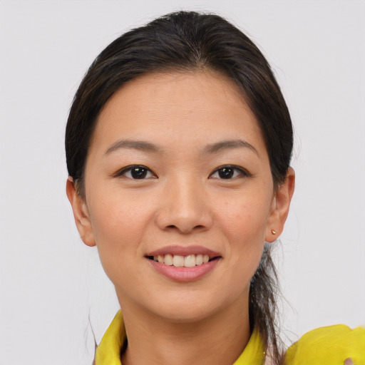 Joyful asian young-adult female with medium  brown hair and brown eyes