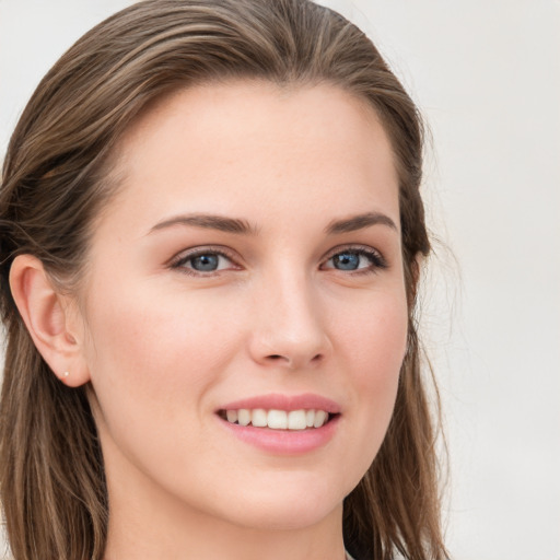 Joyful white young-adult female with long  brown hair and blue eyes