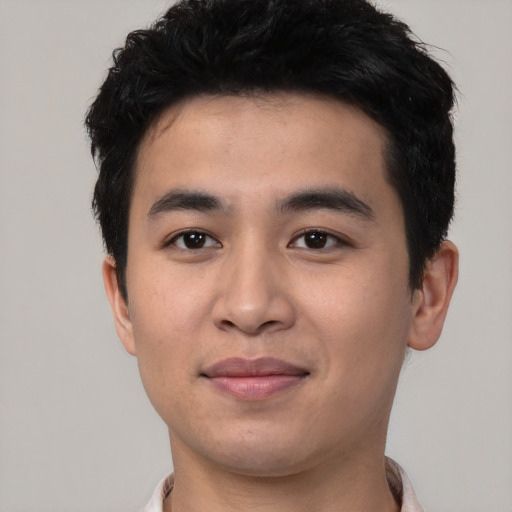 Joyful asian young-adult male with short  black hair and brown eyes