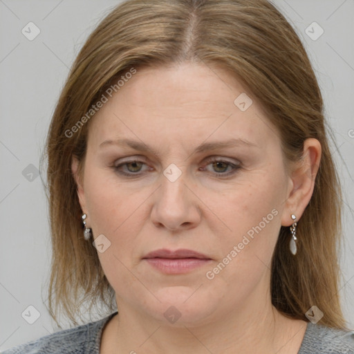 Joyful white adult female with medium  brown hair and blue eyes