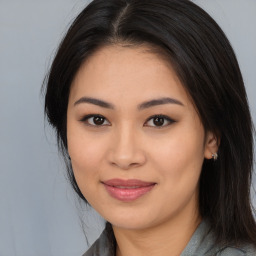 Joyful latino young-adult female with long  brown hair and brown eyes