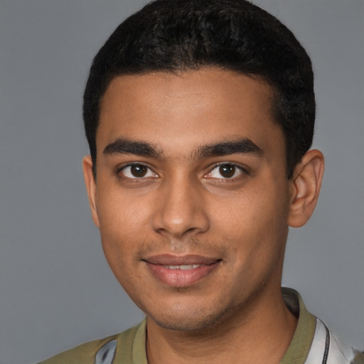 Joyful latino young-adult male with short  brown hair and brown eyes